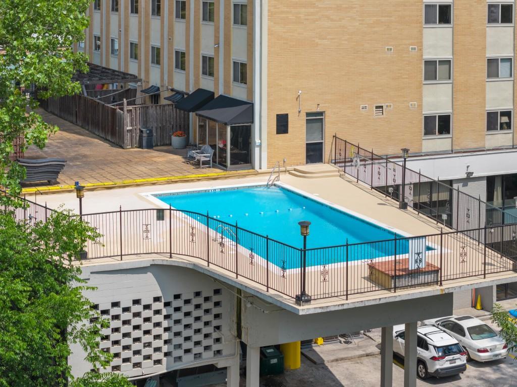 2285 Peachtree Street Northeast, Unit 801 Atlanta, GA 30309 - Photo 25 of 30 a blue swimming pool with outdoor seating and yard