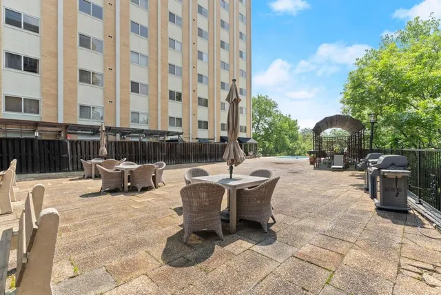 a view of a patio with couches and potted plants