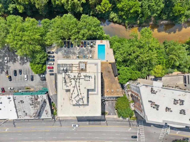 an aerial view of residential house with outdoor space and seating area