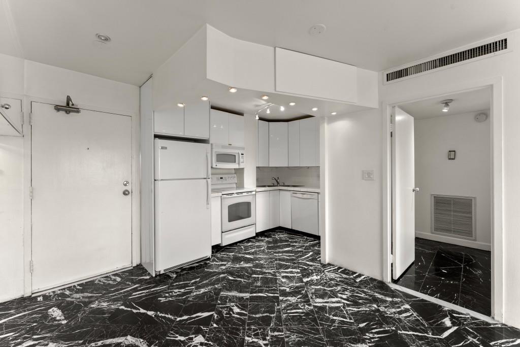 2285 Peachtree Street Northeast, Unit 801 Atlanta, GA 30309 - Photo 8 of 30 a kitchen with stainless steel appliances granite countertop a refrigerator and a stove top oven