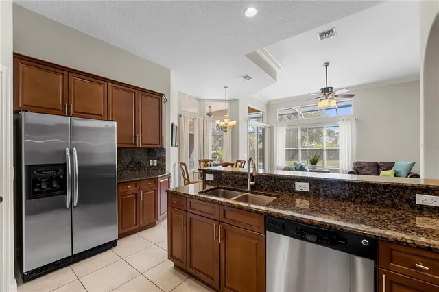 a kitchen with granite countertop a sink and stainless steel appliances
