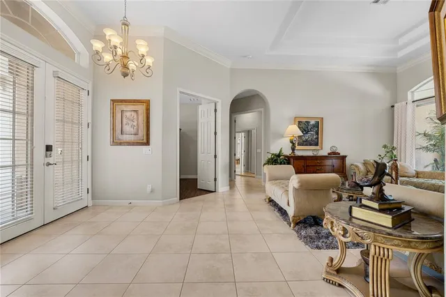a living room with furniture and a chandelier