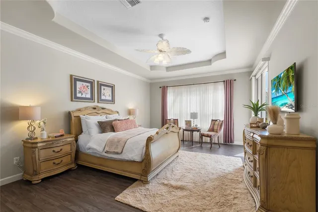 a bedroom with furniture and a flat screen tv