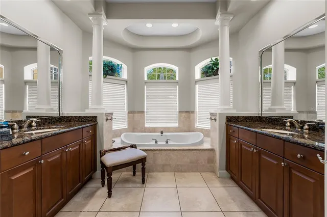 a bathroom with a granite countertop sink a mirror and a shower