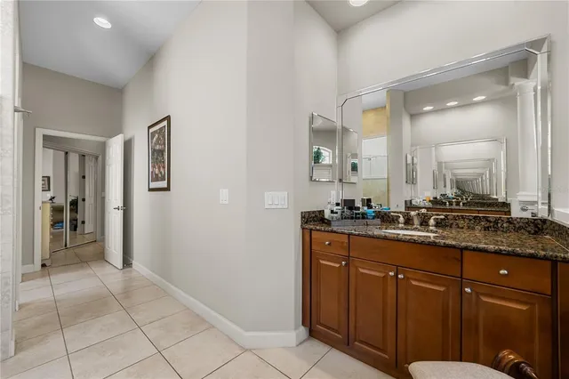 a bathroom with a double vanity sink toilet and a mirror