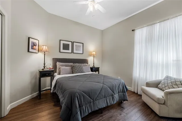 a bathroom with a granite countertop toilet a sink and a mirror