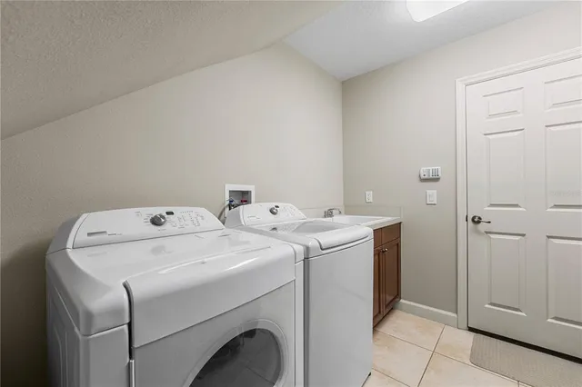 a view of a tennis ground with large trees