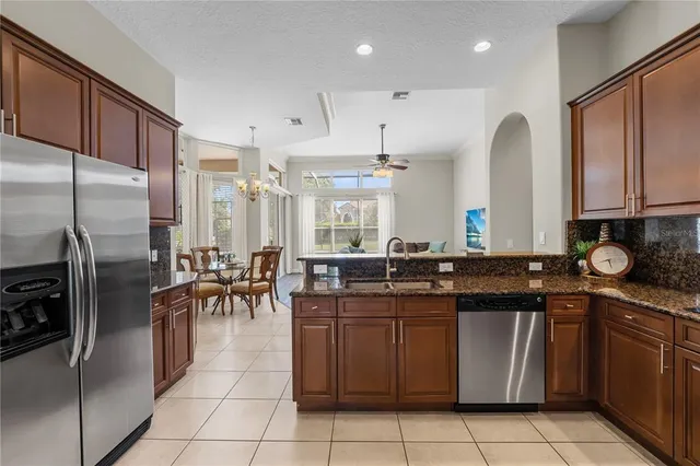 a kitchen with stainless steel appliances granite countertop a stove a sink a microwave and a refrigerator