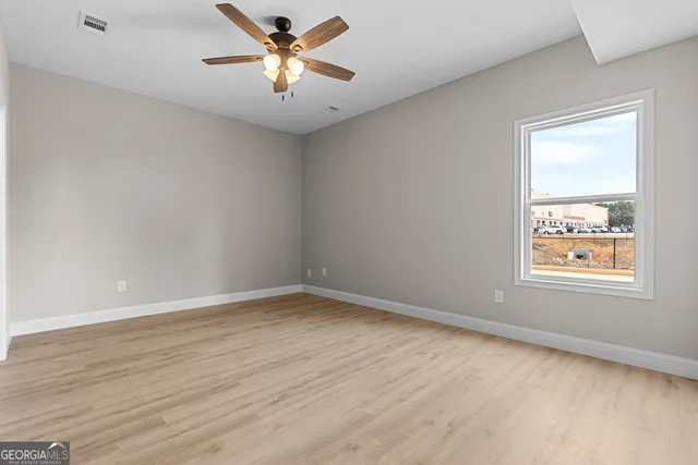 wooden floor in an empty room with a window