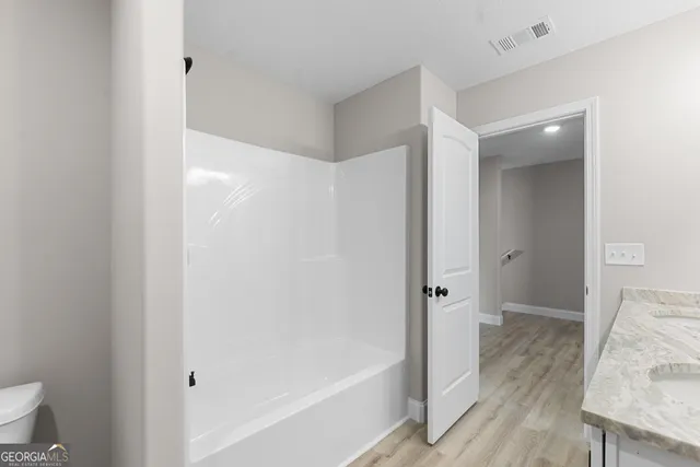 a bathroom with a tub and shower