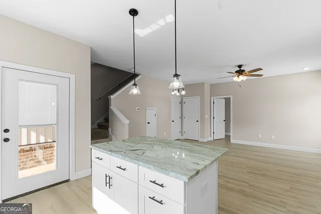 a kitchen with a stove kitchen island and windows