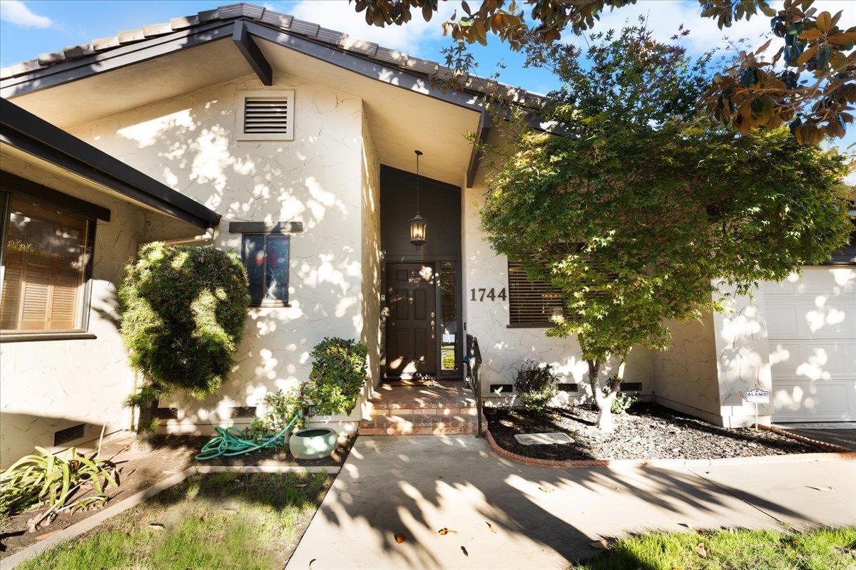 a view of a house with yard patio and sitting area