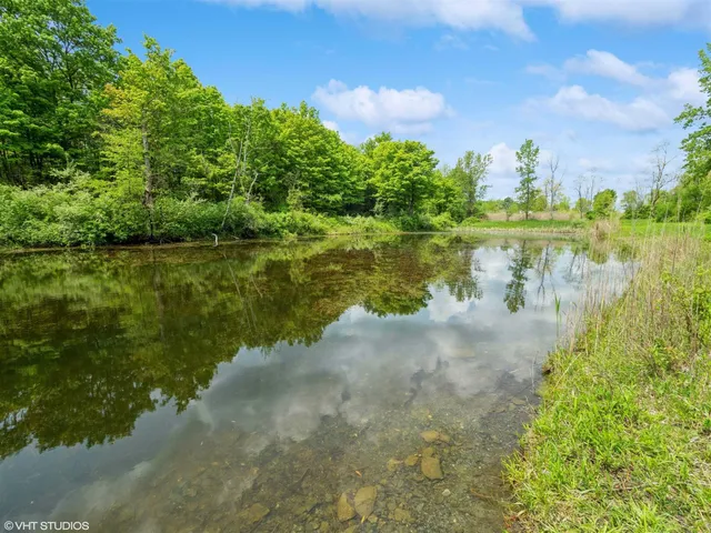a view of a lake with houses in the back