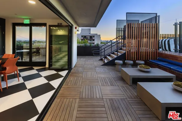 an aerial view of a house with a barbeque and wooden stairs
