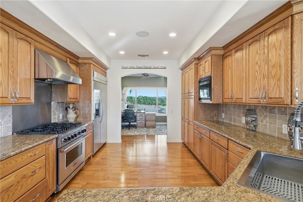 220 Cook Court Templeton, CA 93465 - Photo 15 of 45 a kitchen with stainless steel appliances granite countertop a stove a sink and a microwave
