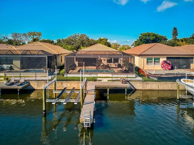 a view of a house with pool and chairs
