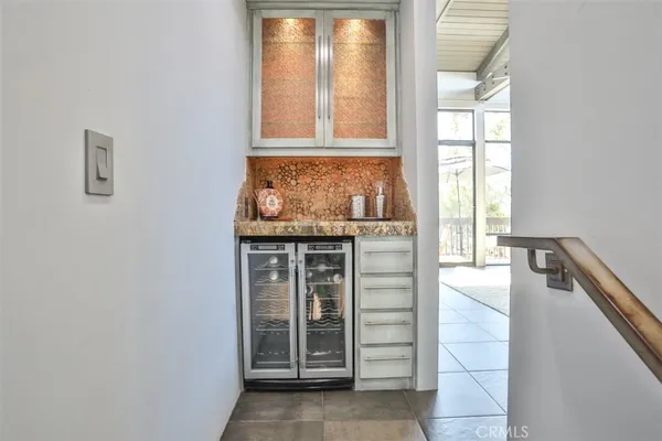 a bedroom with a large bed and a mirror