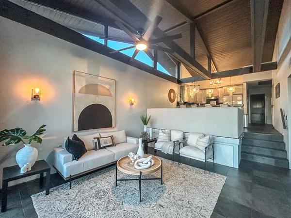 a living room with furniture and a fireplace