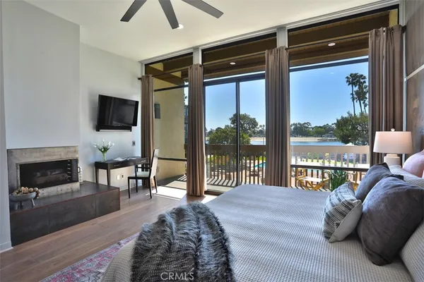 a bedroom with a large bed and a large window with outer view