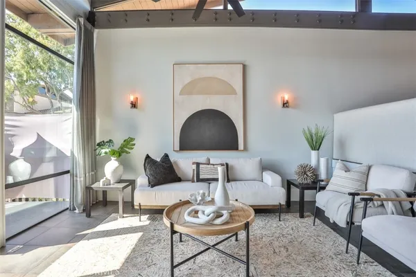a living room with furniture and a potted plant