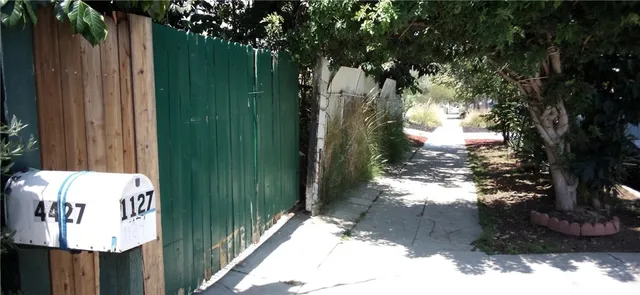 a view of a patio with table and chairs with a large tree