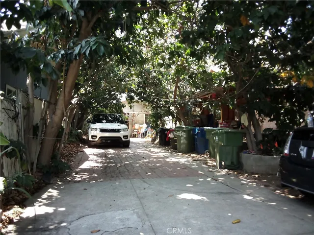 a patio with table and chairs and potted plants
