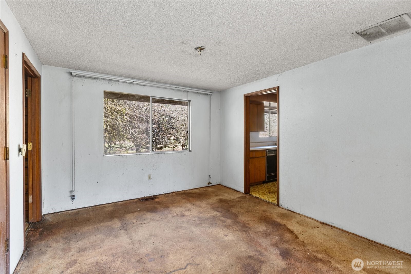 38425 Swede Heaven Road Arlington, WA 98223 - Photo 7 of 36 a view of an empty room with wooden floor and a window