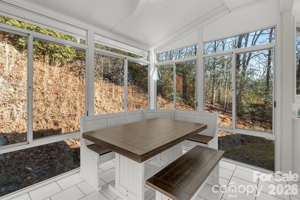 56 Great Horned Owl Road Candler, NC 28715 - Photo 10 of 32 a view of a living room and floor to ceiling window with wooden floor