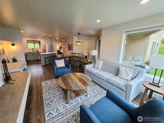 a living room with furniture and kitchen view