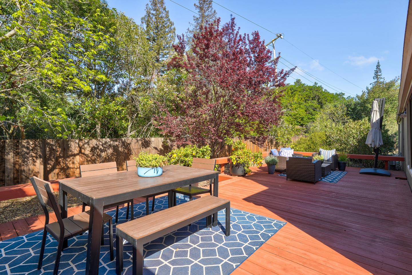 7 Farm Road Los Altos, CA 94024 - Photo 20 of 38 a backyard of a house with table and chairs