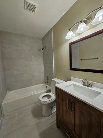 a bathroom with a sink a toilet and bathtub