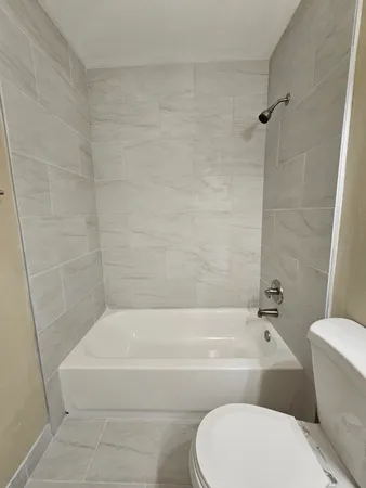 a bathroom with a toilet and bathtub