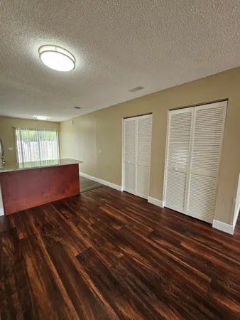 a view of wooden floor and windows in a room