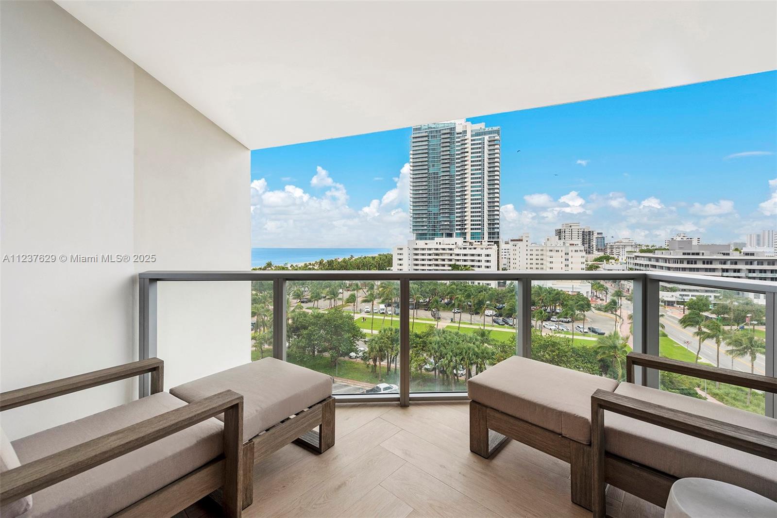 2201 Collins Avenue, Unit 804 Miami Beach, FL 33139 - Photo 2 of 41 a living room with furniture and a floor to ceiling window