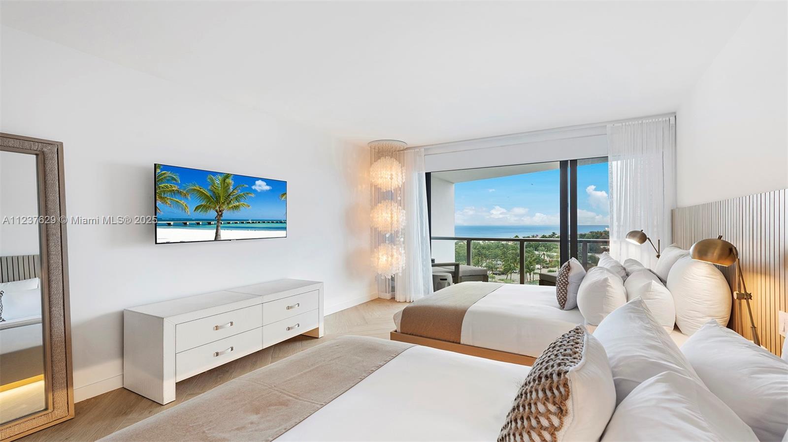 2201 Collins Avenue, Unit 804 Miami Beach, FL 33139 - Photo 21 of 41 a bedroom with a bed and a night stand