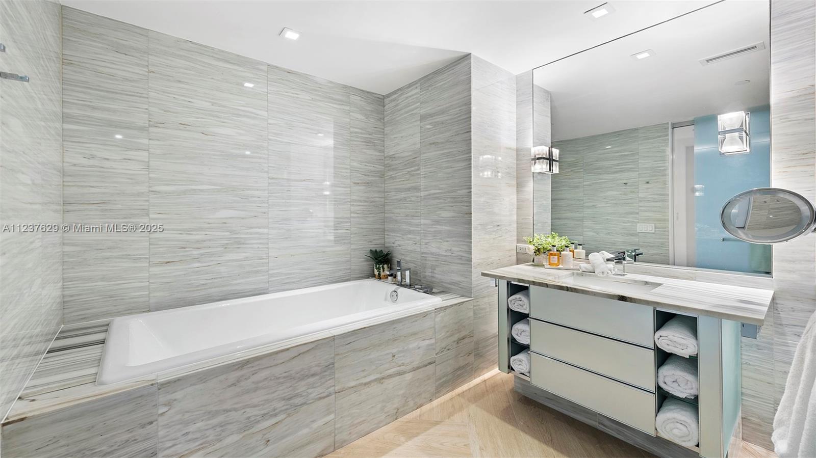 2201 Collins Avenue, Unit 804 Miami Beach, FL 33139 - Photo 26 of 41 a bathroom with a bathtub and a sink