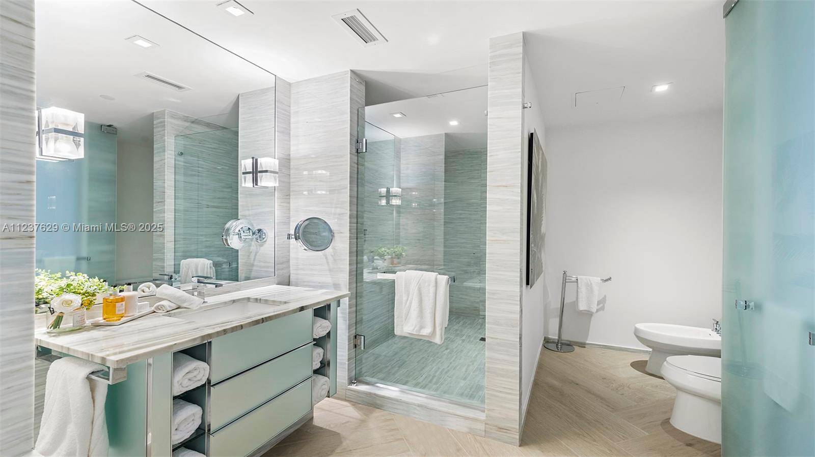 2201 Collins Avenue, Unit 804 Miami Beach, FL 33139 - Photo 28 of 41 a bathroom with a sink a toilet and shower