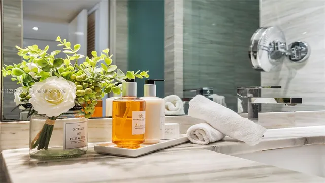 a bathroom with a sink mirror and shower