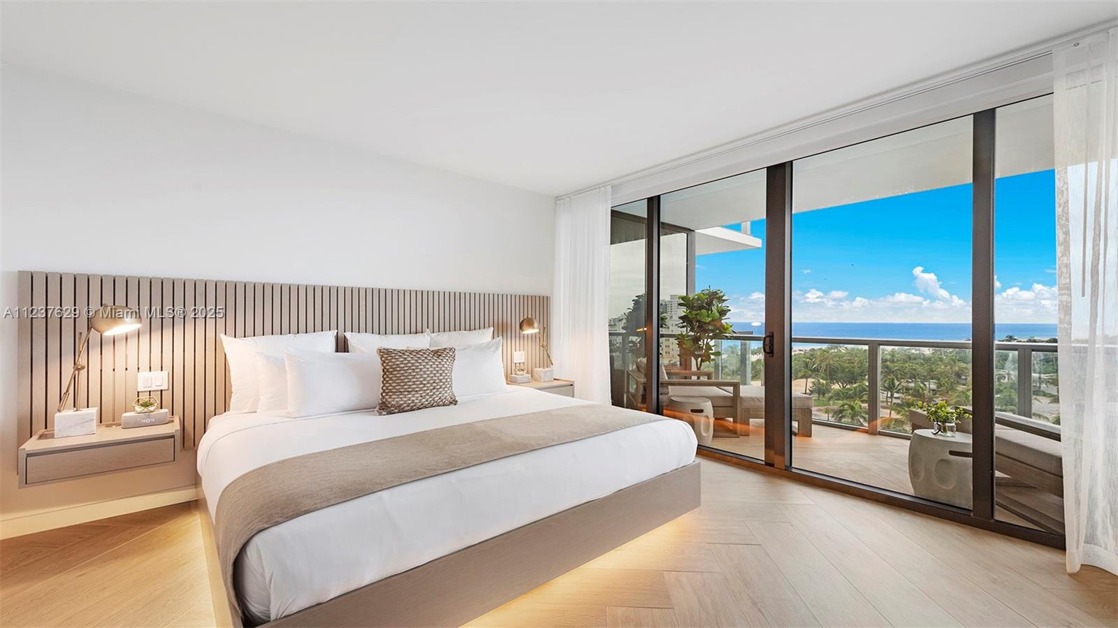 2201 Collins Avenue, Unit 804 Miami Beach, FL 33139 - Photo 3 of 41 a bedroom with a large bed and a large window