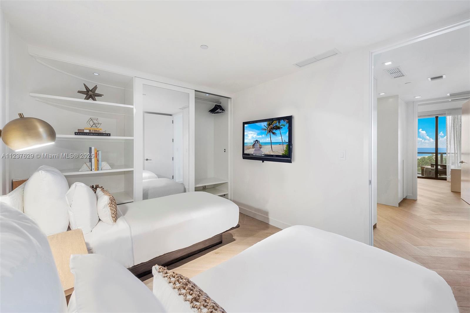 2201 Collins Avenue, Unit 804 Miami Beach, FL 33139 - Photo 32 of 41 a bedroom with a bed and a lamp