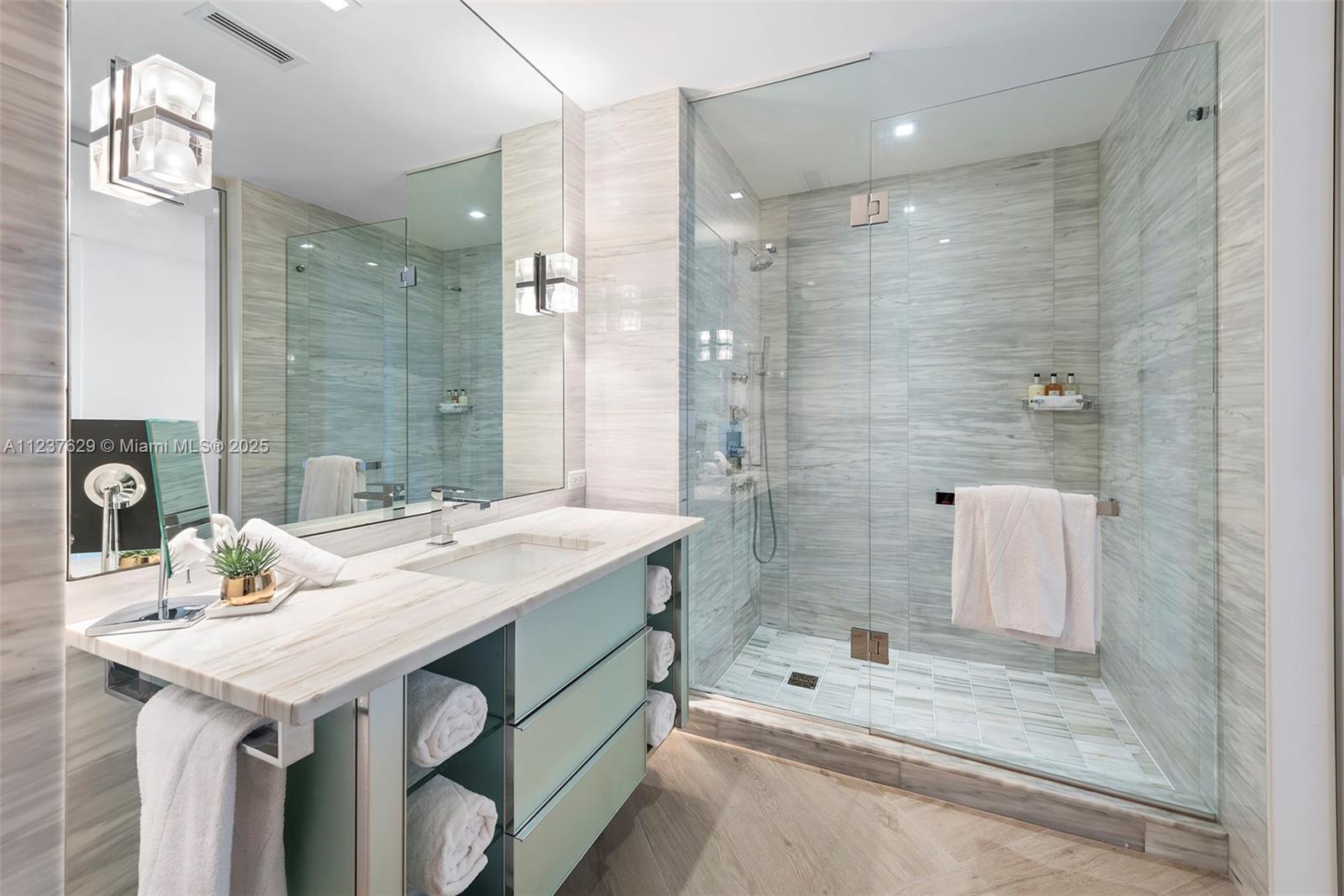 2201 Collins Avenue, Unit 804 Miami Beach, FL 33139 - Photo 35 of 41 a bathroom with a sink double vanity and a shower