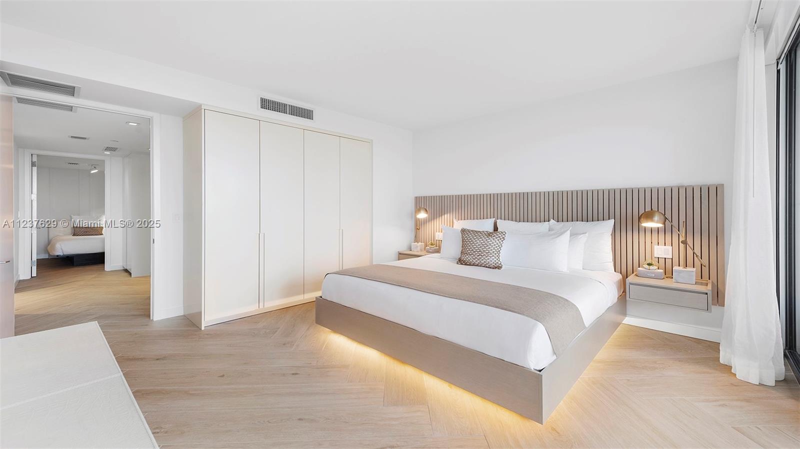 2201 Collins Avenue, Unit 804 Miami Beach, FL 33139 - Photo 36 of 41 a bedroom with a bed and a walk in closet