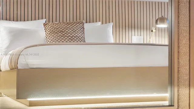 a spacious bedroom with a bed and a flat screen tv