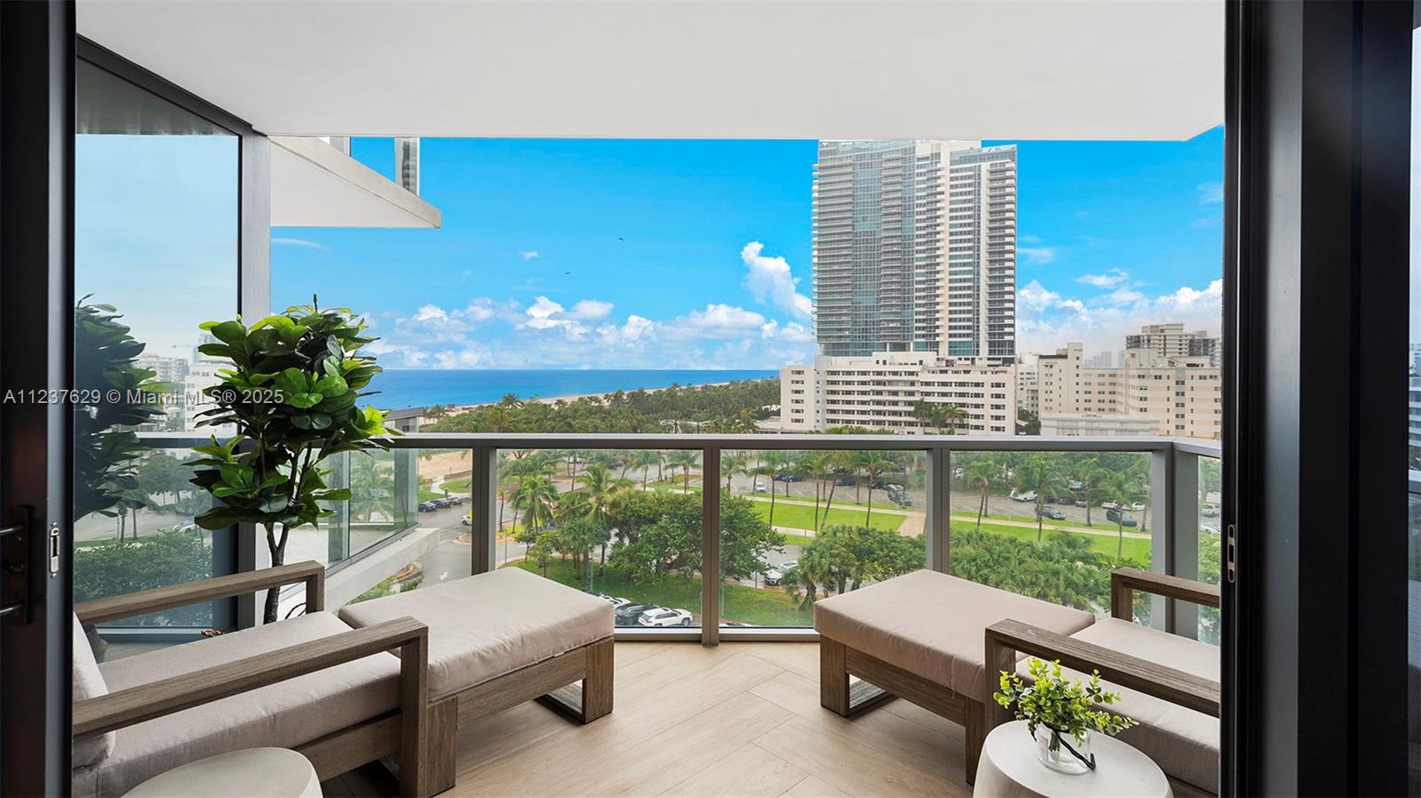 2201 Collins Avenue, Unit 804 Miami Beach, FL 33139 - Photo 41 of 41 a living room with furniture and a large window