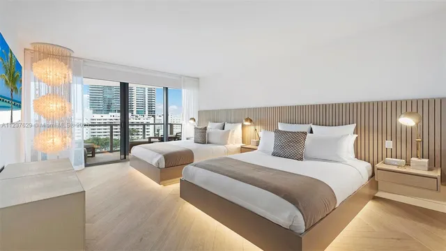 a spacious bedroom with two beds and a large window