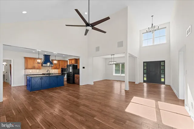 a living room with furniture and kitchen view