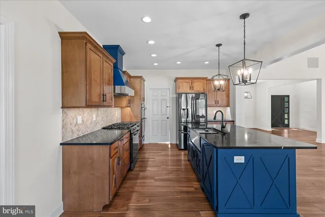 a kitchen with granite countertop a sink and stove