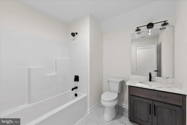 a view of a big room with wooden floor and a bathroom