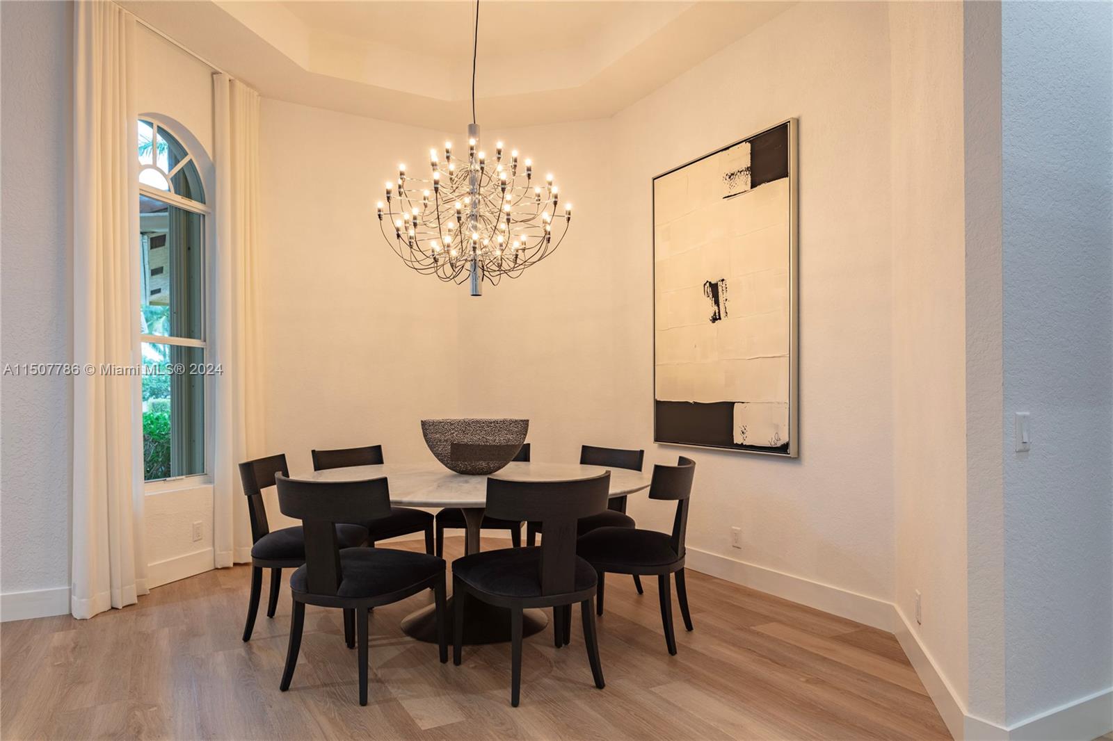 1655 Victoria Pointe Circle Weston, FL 33327 - Photo 11 of 43 a view of a dining room with furniture and chandelier