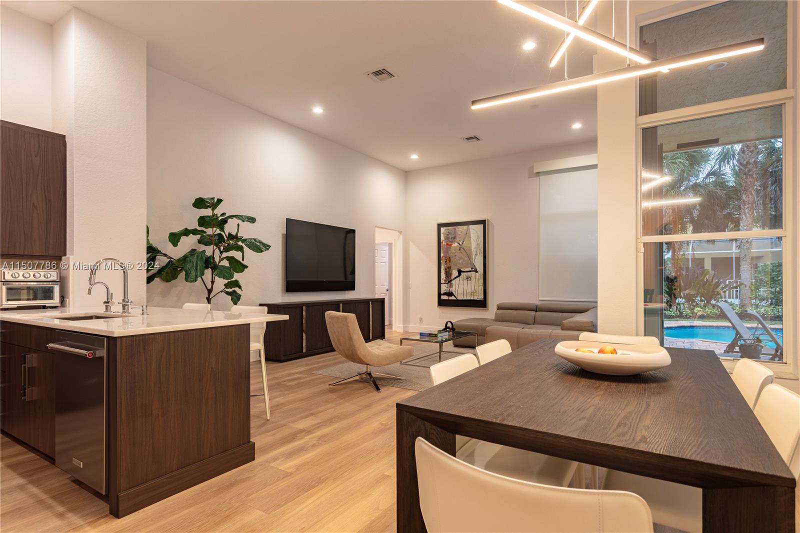 1655 Victoria Pointe Circle Weston, FL 33327 - Photo 12 of 43 a living room with furniture and a flat screen tv